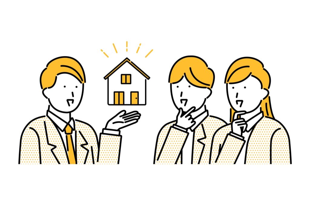 住宅について解説するビジネスマンと若い夫婦